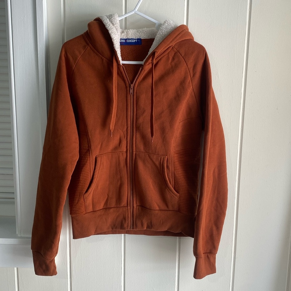 “Roma concept” rust orange zip up sweatshirt. Size large.